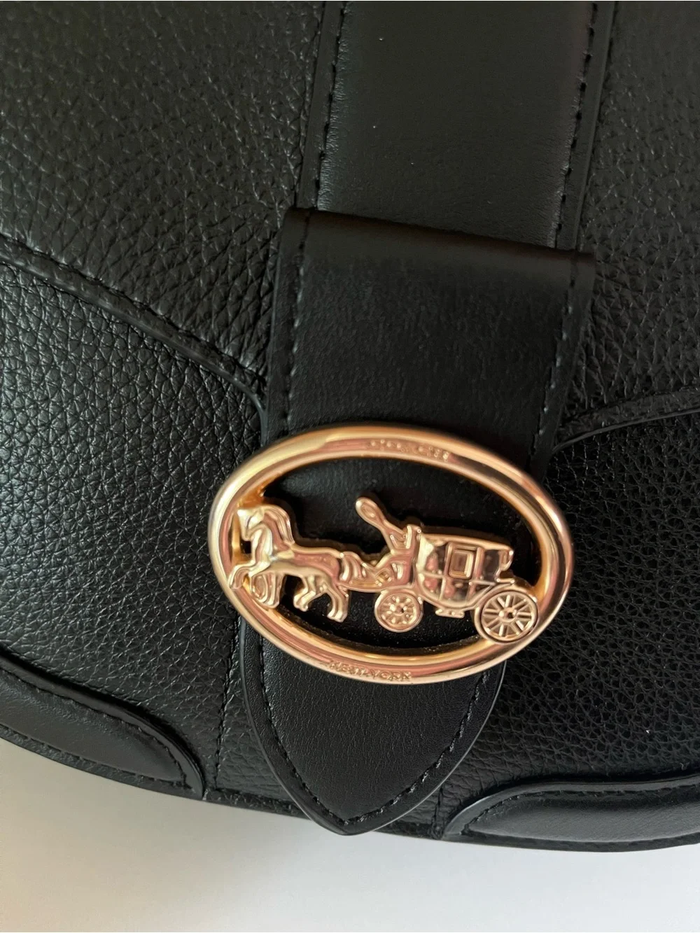 Coach Georgie crossbody saddle bag in black pebbled leather, gold tone hardware